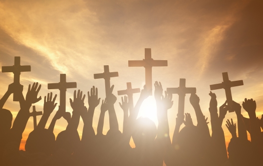 Group of People Holding Cross and Praying in Back Lit Concept